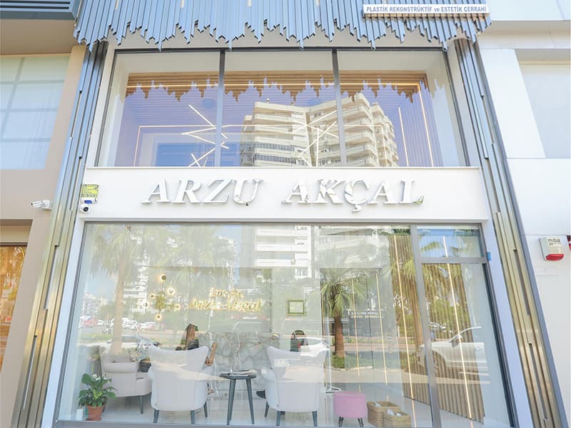 The glass front of the Arzu Akçal clinic, with the waiting area visible inside