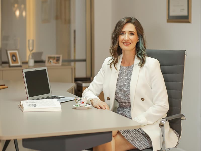Prof. Dr. Arzu Akçal at her desk in the clinic