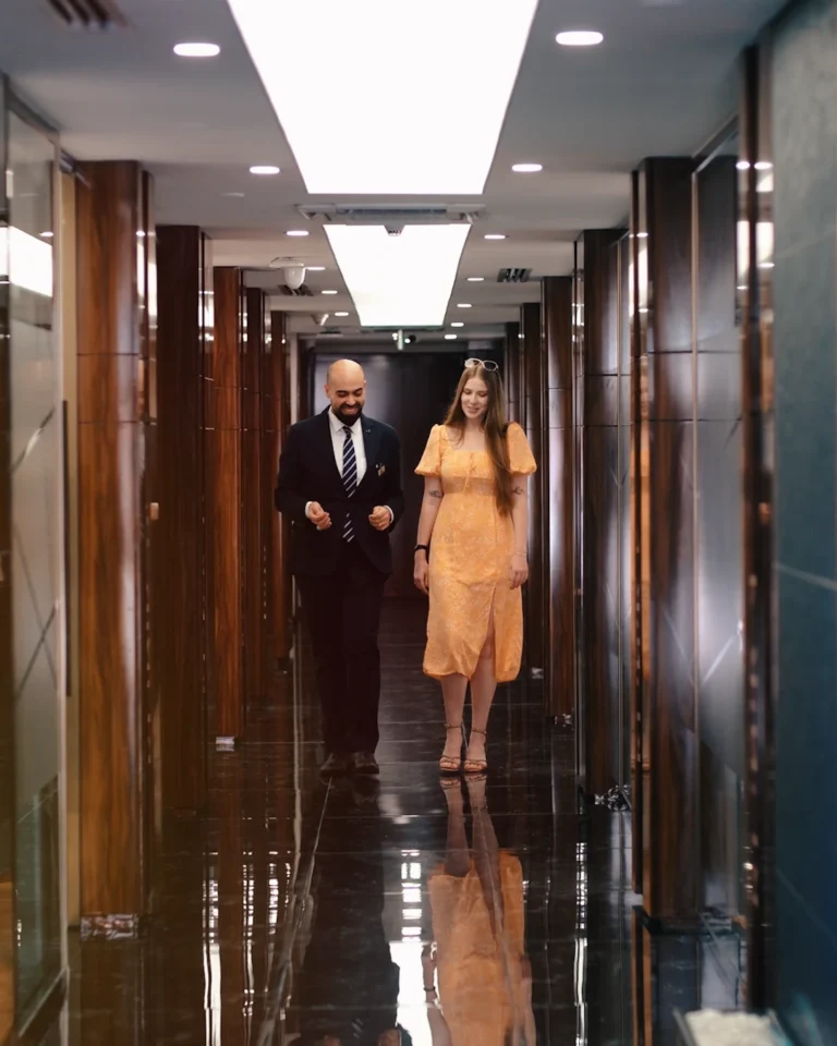 A DentSpa staff member walking a patient down the clinic’s marble corridor