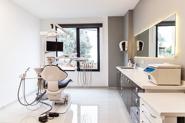 A treatment room at Focus Dental Clinic with a dental chair by the window