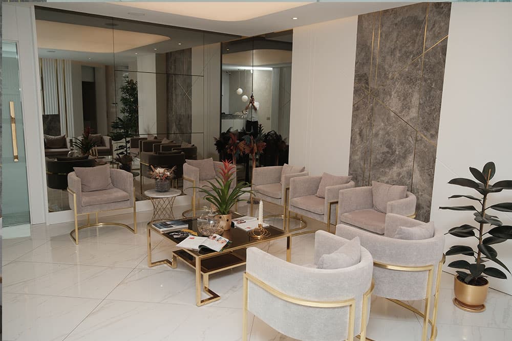 The patient lounge at Op. Dr. Onur Oğan’s clinic, with armchairs and marble walls